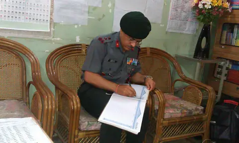 BRIG MONISH WRITES HIS COMMENTS IN THE VISTORS BOOK