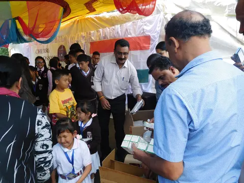 MEMBERS OF THE KERALA CLUB GIVING AWAY SNACKS AND STATIONARY ITEMS 
